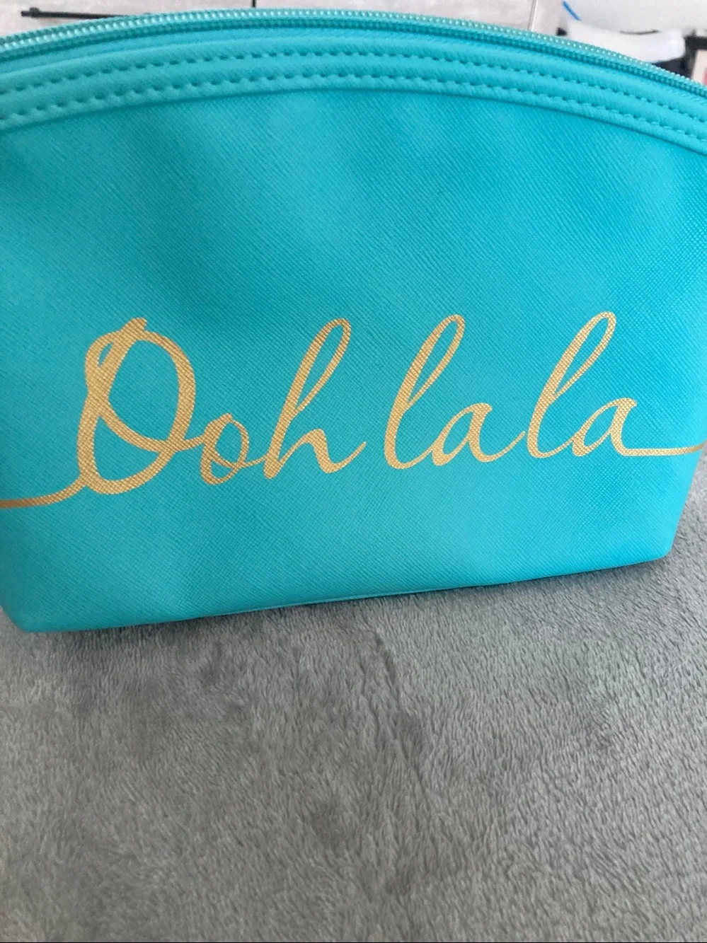 Turquoise colored faux leather cosmetic bag